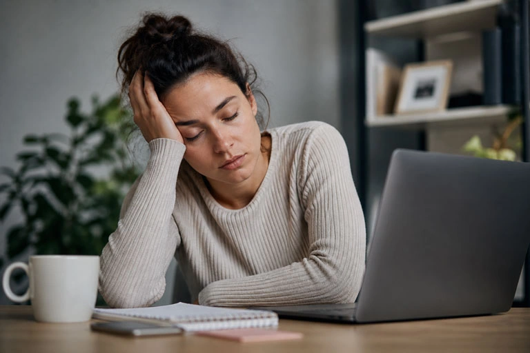 Tired person hitting the mid-afternoon energy wall on a low-carb diet